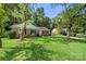 Charming brick home with lush front yard and mature trees in a quiet neighborhood at 6215 Cross Creek Ln, Charlotte, NC 28212