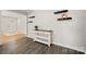 Hallway with dark vinyl floors and an inviting console table with shelving at 6215 Cross Creek Ln, Charlotte, NC 28212