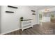 Hallway with dark vinyl floors and an inviting console table with shelving at 6215 Cross Creek Ln, Charlotte, NC 28212