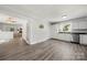 Open-concept kitchen with stainless appliances and white cabinets, seamless transition into living space at 6215 Cross Creek Ln, Charlotte, NC 28212