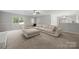 Spacious living room features a large sectional couch, ottoman, and lots of natural light at 6215 Cross Creek Ln, Charlotte, NC 28212
