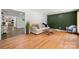 Bright living room featuring wood floors, a modern sofa, and ample natural light at 6215 Cross Creek Ln, Charlotte, NC 28212