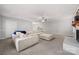 Open-concept living room features a large sectional sofa, ceiling fan, and freshly painted fireplace at 6215 Cross Creek Ln, Charlotte, NC 28212
