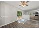 Bright room with LVP flooring, ceiling fan, and backyard views through sliding glass door at 6215 Cross Creek Ln, Charlotte, NC 28212