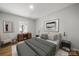 Staged primary bedroom showcases hardwood floors, neutral decor and large window at 6215 Cross Creek Ln, Charlotte, NC 28212