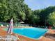Community pool with plenty of lounge chairs, table, and shade, perfect for relaxing on summer days at 6215 Cross Creek Ln, Charlotte, NC 28212
