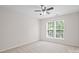 Neutral bedroom features ceiling fan and large windows providing natural light at 6803 Augustine Way, Charlotte, NC 28270