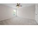 Bedroom features ceiling fan and a large window at 6803 Augustine Way, Charlotte, NC 28270