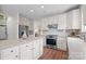 Modern kitchen features stainless appliances, white cabinets, subway tile backsplash, and an island with seating at 6803 Augustine Way, Charlotte, NC 28270