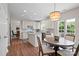 Bright eat-in kitchen features white cabinetry, stainless steel appliances, an island, and a casual dining area at 6803 Augustine Way, Charlotte, NC 28270