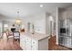 Spacious kitchen with island, stainless steel appliances, dining area, and easy flow into the living room at 6803 Augustine Way, Charlotte, NC 28270