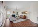 Bright living room featuring a cozy fireplace, neutral paint, and wood floors at 6803 Augustine Way, Charlotte, NC 28270