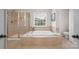 Main bathroom featuring a soaking tub and separate shower at 6803 Augustine Way, Charlotte, NC 28270