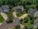 Aerial view of a beautiful home with a circular driveway and mature trees at 7700 Antique Cir, Waxhaw, NC 28173