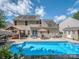 Beautiful backyard featuring a pool, patio, pergola, and well-maintained landscaping at 7700 Antique Cir, Waxhaw, NC 28173