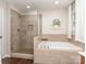Well-appointed bathroom featuring a glass-enclosed shower, soaking tub, and a neutral color palette at 7700 Antique Cir, Waxhaw, NC 28173