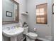 This powder room features a decorative mirror, pedestal sink, and a comfort-height toilet at 7700 Antique Cir, Waxhaw, NC 28173