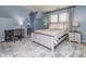 Comfortable bedroom with a desk, a patterned rug, and a large cozy bed at 7700 Antique Cir, Waxhaw, NC 28173