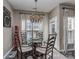 Well-lit dining room features a glass table, seating for four, and a decorative chandelier at 7700 Antique Cir, Waxhaw, NC 28173