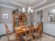 Elegant dining room with classic wood furniture, wainscoting, and a stylish chandelier at 7700 Antique Cir, Waxhaw, NC 28173