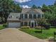 Charming two-story home with lush landscaping and a well-manicured lawn at 7700 Antique Cir, Waxhaw, NC 28173