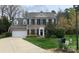 Charming two-story brick home with a well-manicured lawn, two-car garage, and classic black shutters at 7700 Antique Cir, Waxhaw, NC 28173