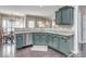 Modern kitchen featuring green cabinets, granite countertops, stainless steel appliances, and hardwood floors at 7700 Antique Cir, Waxhaw, NC 28173