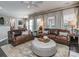 Cozy living room with leather sofas and light filtering curtains at 7700 Antique Cir, Waxhaw, NC 28173