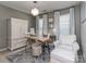 Well-lit home office features two desks, a comfortable chair, and a built-in cabinet at 7700 Antique Cir, Waxhaw, NC 28173