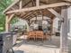 Relaxing outdoor dining area under a wooden pergola with an outdoor kitchen at 7700 Antique Cir, Waxhaw, NC 28173
