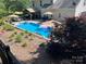 Aerial view of the backyard pool with cabana, umbrellas, lounge chairs, and meticulous landscaping at 7700 Antique Cir, Waxhaw, NC 28173