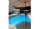 Sparkling blue pool with sun umbrellas, shed, and inviting lounging areas for outdoor relaxation and enjoyment at 7700 Antique Cir, Waxhaw, NC 28173