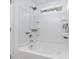 Clean white tub and shower combo features a shower head with a window to provide natural light at 858 Rook Rd, Charlotte, NC 28216