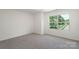 Bright bedroom featuring a large window offering plenty of natural light at 858 Rook Rd, Charlotte, NC 28216