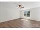 Bright bedroom with a ceiling fan, wood-look floors, and a large window at 858 Rook Rd, Charlotte, NC 28216