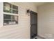 Charming entrance with a black screen door and classic exterior lighting at 858 Rook Rd, Charlotte, NC 28216