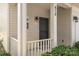 Inviting front porch featuring a black door and classic exterior lighting at 858 Rook Rd, Charlotte, NC 28216