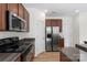 Kitchen showcasing granite counters, stainless steel appliances, and wood cabinets at 858 Rook Rd, Charlotte, NC 28216