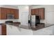 Kitchen featuring granite counters, stainless appliances, and brown wood cabinets at 858 Rook Rd, Charlotte, NC 28216