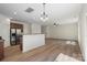 Open concept living and kitchen area with wood floors and stainless steel appliances at 858 Rook Rd, Charlotte, NC 28216