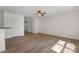 Spacious living room with wood-look flooring, white walls, and archway at 858 Rook Rd, Charlotte, NC 28216