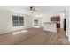Bright living room with wood flooring and an adjacent kitchen area at 858 Rook Rd, Charlotte, NC 28216