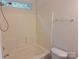Simple bathroom with a shower-tub combination and bright, neutral tile at 8838 Wandering Creek Way, Charlotte, NC 28227