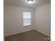 Neutral carpeted bedroom with a window providing natural light at 8838 Wandering Creek Way, Charlotte, NC 28227