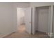 Carpeted bedroom with open closet and view of another room through a doorway at 8838 Wandering Creek Way, Charlotte, NC 28227