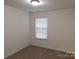 Neutral carpeted bedroom with a window providing natural light at 8838 Wandering Creek Way, Charlotte, NC 28227