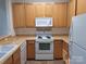 Well-lit kitchen featuring wooden cabinets, modern appliances, and practical countertop space at 8838 Wandering Creek Way, Charlotte, NC 28227