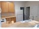 Functional kitchen featuring light wood cabinets, white appliances, and a double-basin sink at 8838 Wandering Creek Way, Charlotte, NC 28227