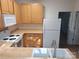 Well-lit kitchen featuring matching appliances, ample counter space, and light wood cabinets at 8838 Wandering Creek Way, Charlotte, NC 28227