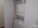 Stackable white washer and dryer unit with access panel at 8838 Wandering Creek Way, Charlotte, NC 28227